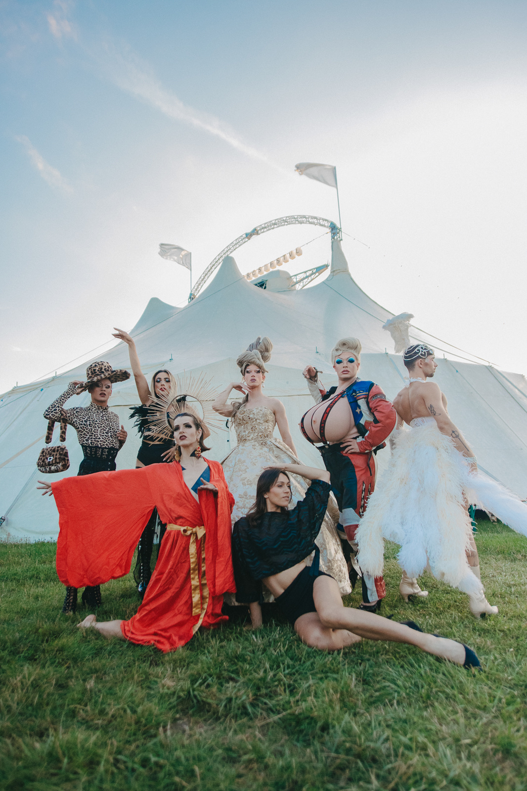 seven women posing in front of a circus tent