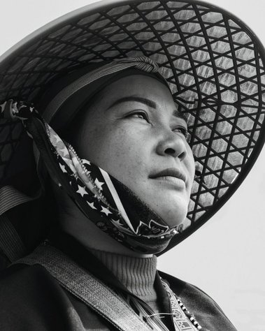 close up of woman in black and white photo wearing a Vietnamese hat
