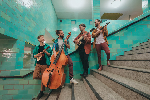four men with instruments at the Berlin train station