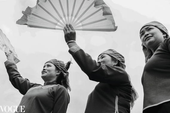 three women dancing with fans