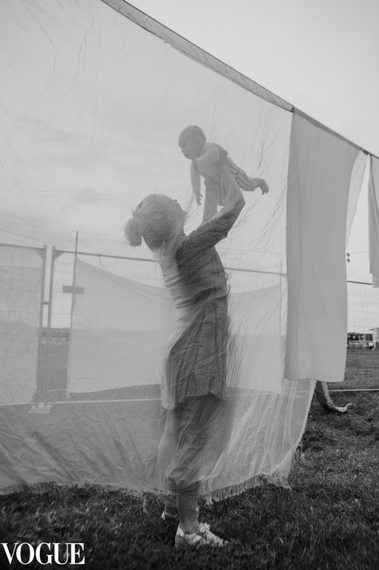 Mother holding her son in her arms and lifting him up. Black and white photo