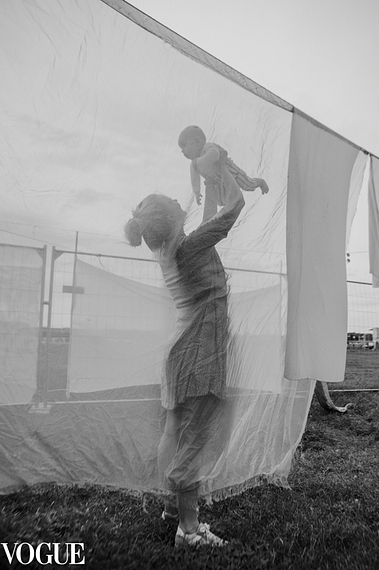 Mother holding her son in her arms and lifting him up. Black and white photo