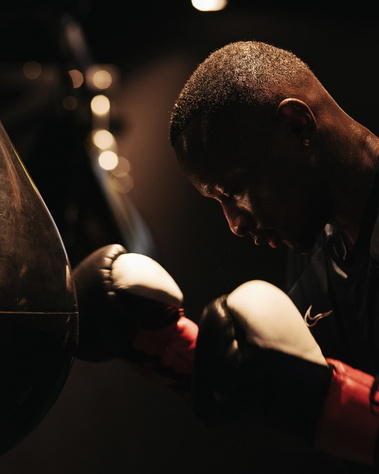 boxer hitting punching bag in gymnasium