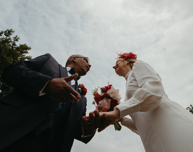 shot from below of a couple embracing with the sky in the background