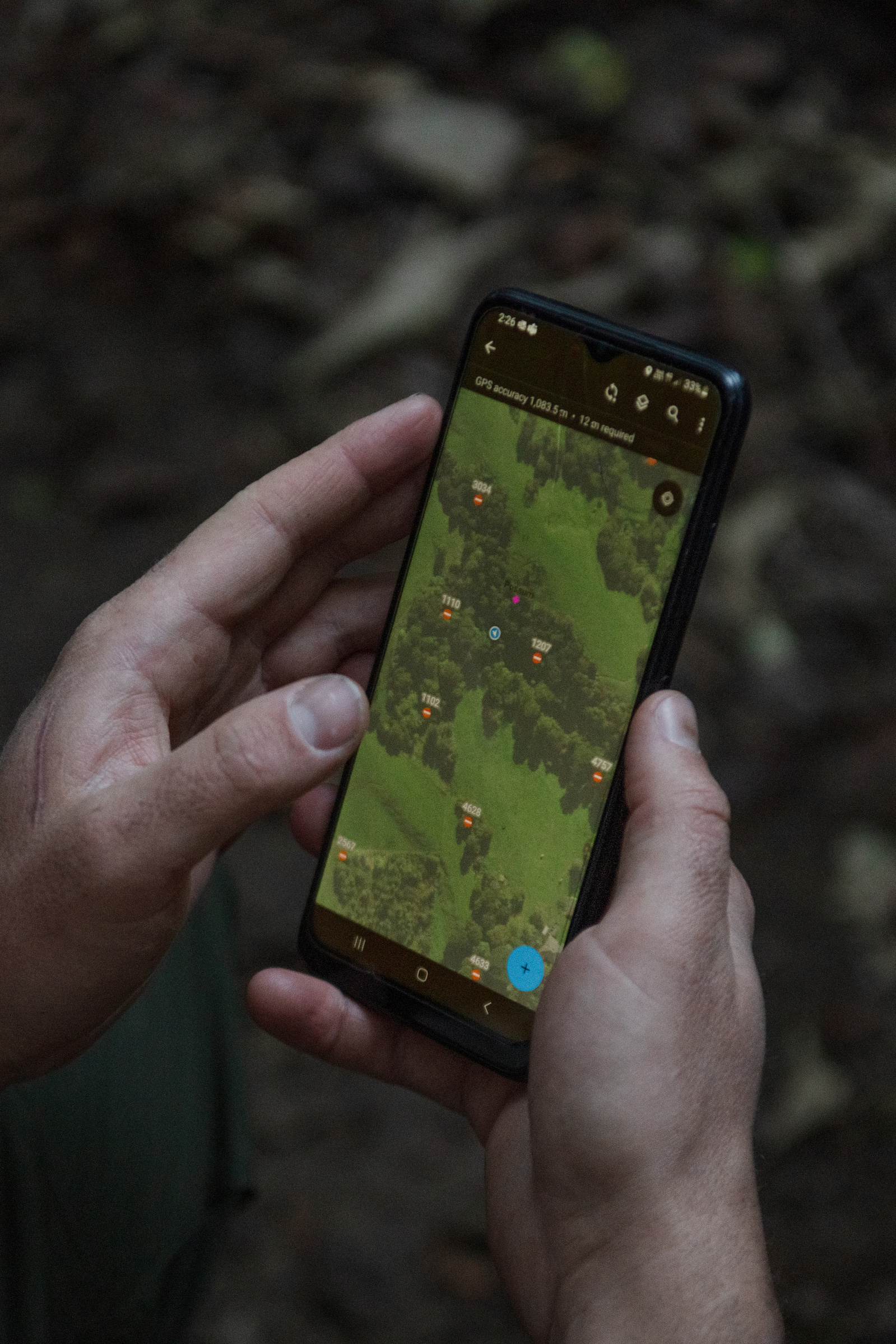Pest Free Banks Peninsula team member Ollie Rutland-Sims updates the app while inspecting the farm for any remaining possums near Akaroa, Banks Peninsula, New Zealand on Thursday, May 8, 2024.