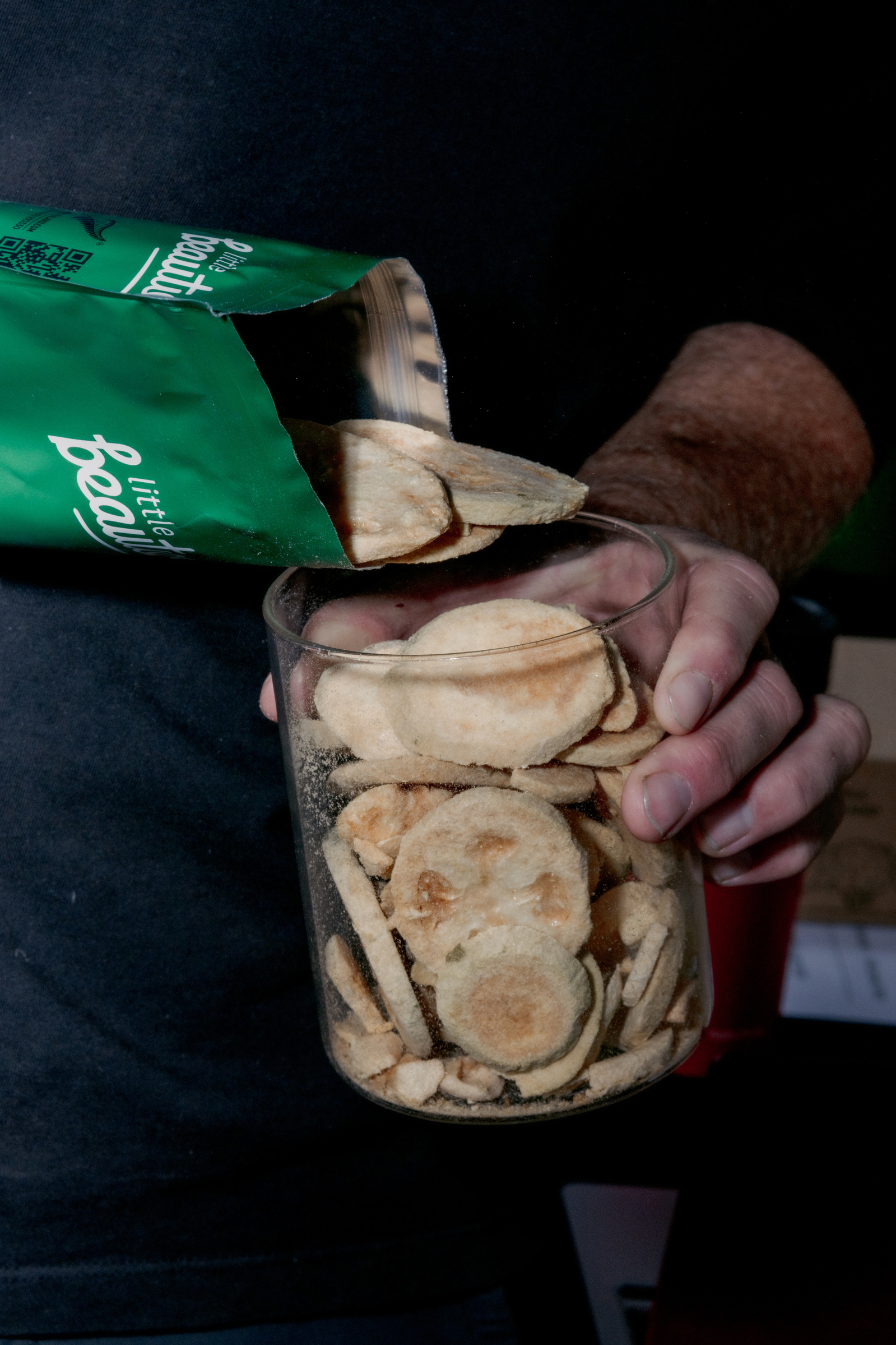 Rob Simcic, Director of the freeze-dried fruit company Little Beaties, fills ups the sample jar of his most popular feijoa freeze-dried fruit product at the market in Nelson, New Zealand on Saturday, April 6, 2024 In New Zealand, the arrival of fall is