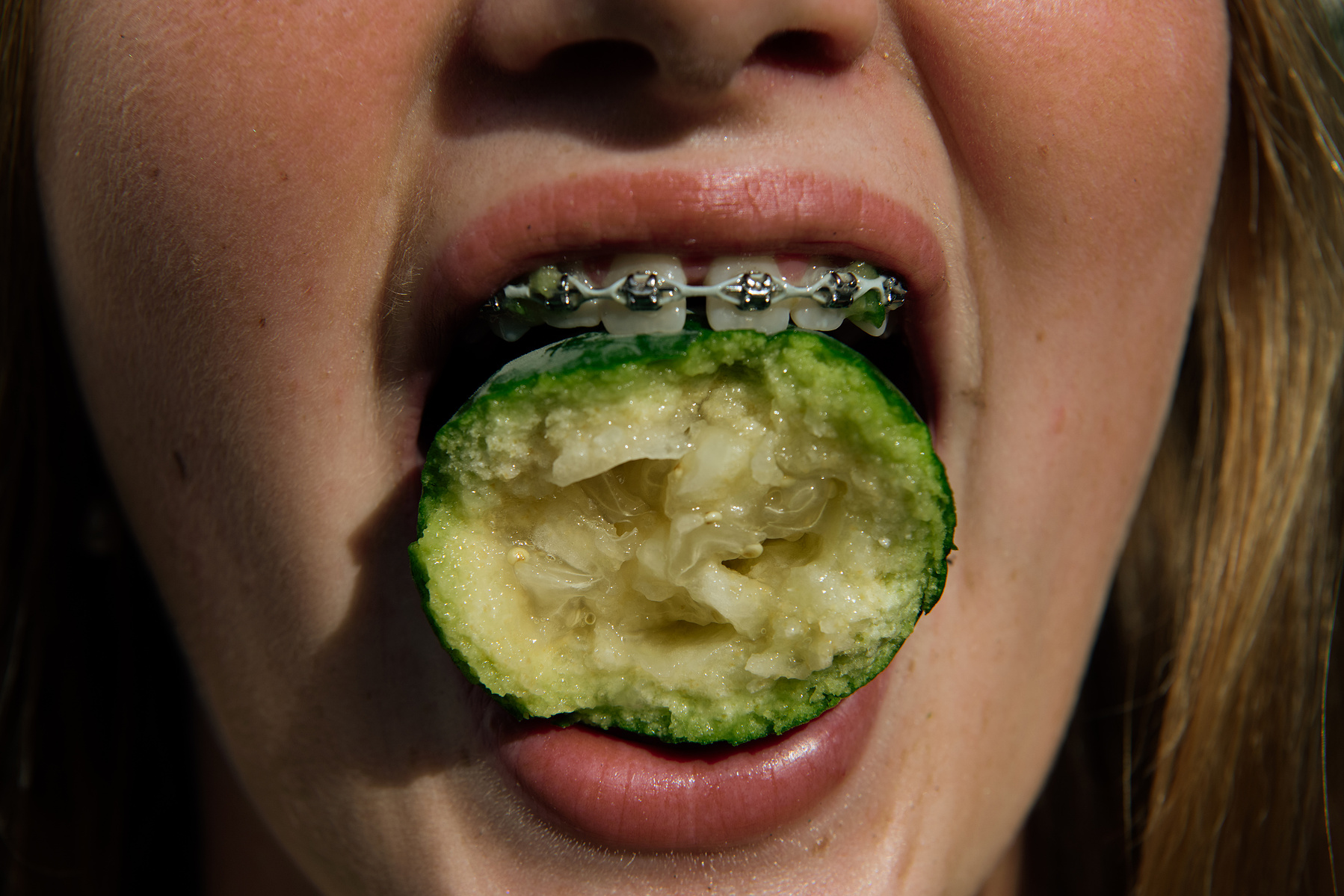 Lola-Rosa Seton, 12, poses for a portrait with a feijoa fruit in her family's garden, which boasts a large feijoa tree, in Nelson, New Zealand on Saturday, April 6, 2024. In New Zealand, the arrival of fall is marked by the distinctive flavor of feijoas,
