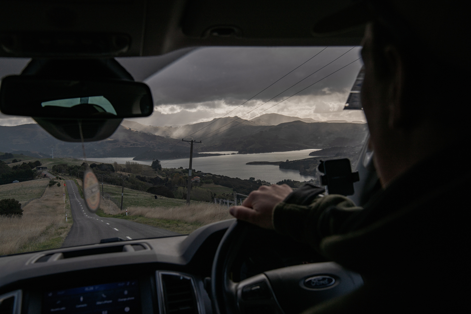 Pest Free Banks Peninsula team member Ollie Rutland-Sims drives to the next location near Akaroa, Banks Peninsula on May 9, 2024.