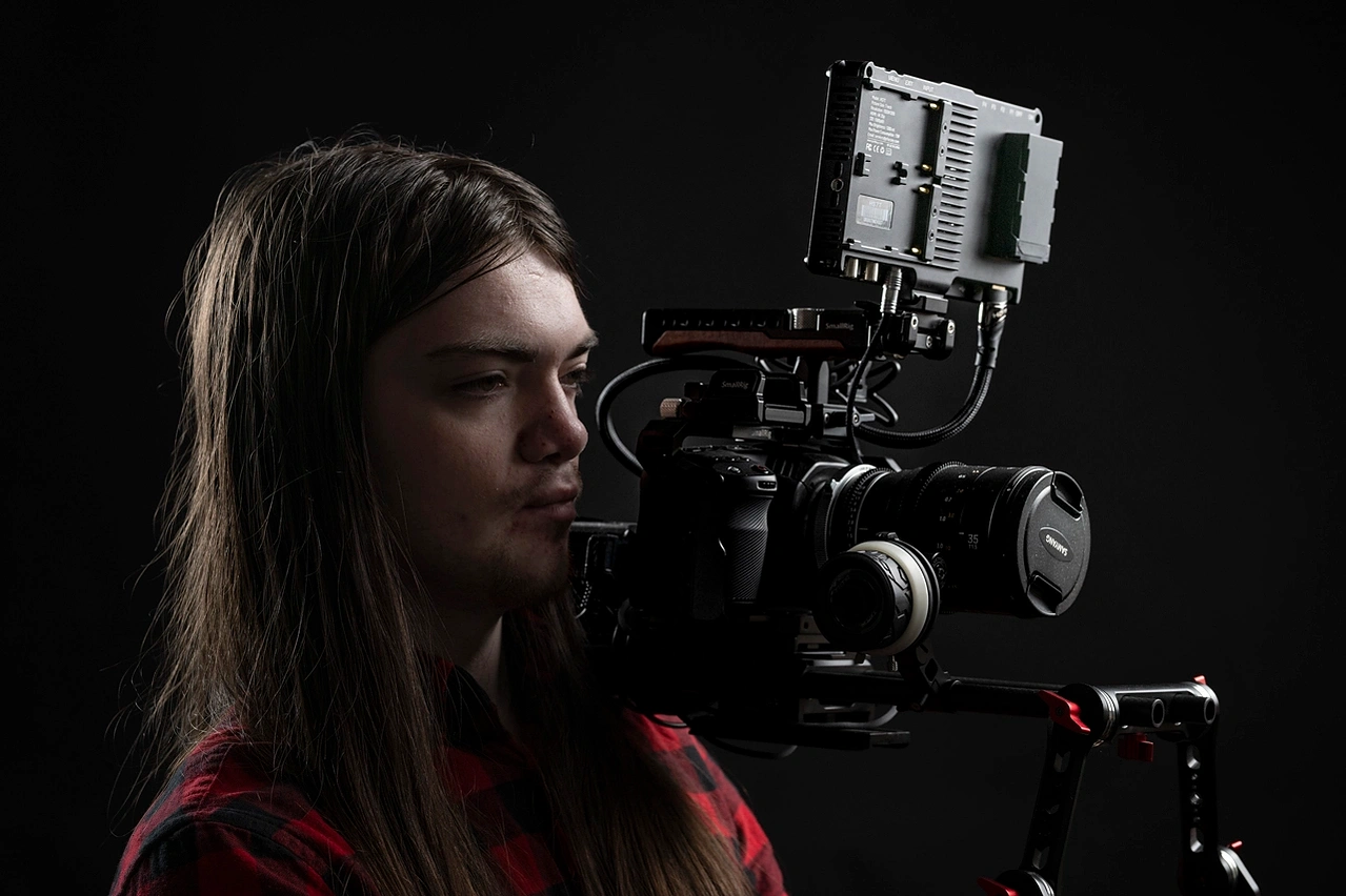 Profile picture of videographer using a shoulder mounted BMPC4K headshots photographed by Mark Wheelwright from Aire Street Studios Leeds