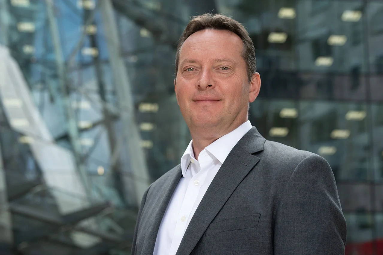Profile picture of business entrepreneur outdoor on glass blue and steel headshots photographed by Mark Wheelwright from Aire Street Studios Leeds