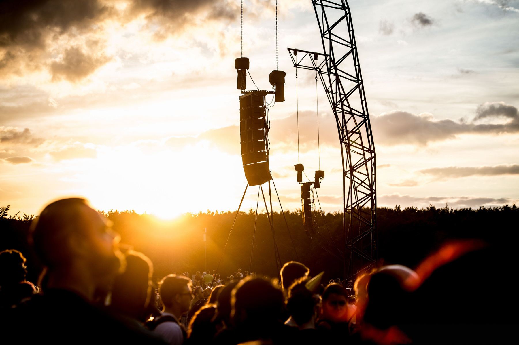 Sunset at Leeds Festival 2022 Orange glow as sun sets across silhouetted crowd photographed by Mark Wheelwright from Aire Street Studios Leeds