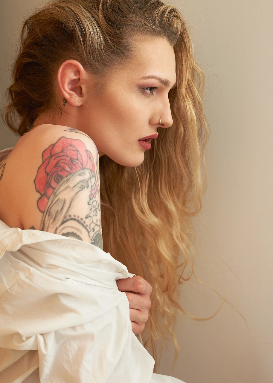 Tattooed model girl with blonde long curly hair photographed at Aire Street Studio & Headshots Leeds