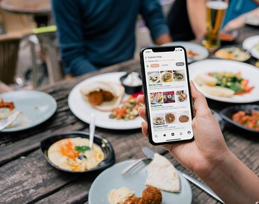 Person using phone at restaurant