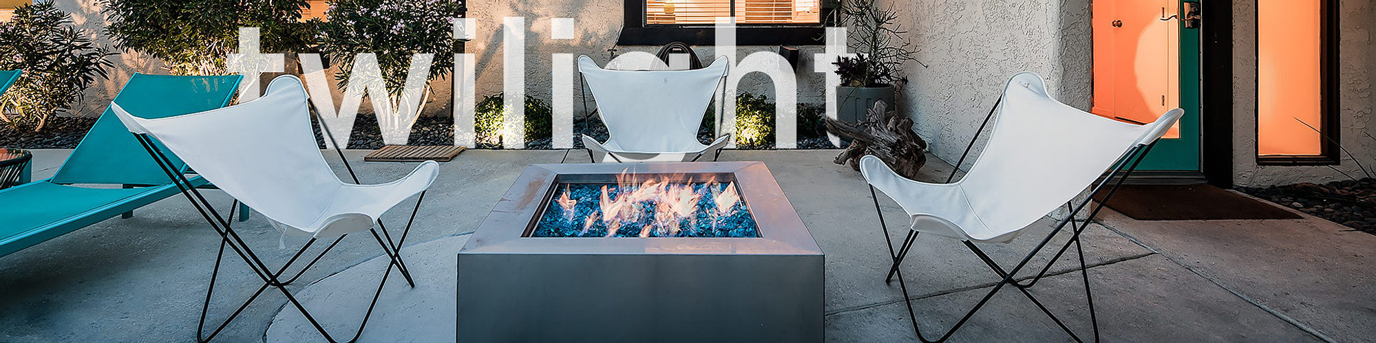 Butterfly chairs at twilight around a glowing fire pit at a Cathedral City Cove vacation rental, photographed by Craig Bernardi Photograph