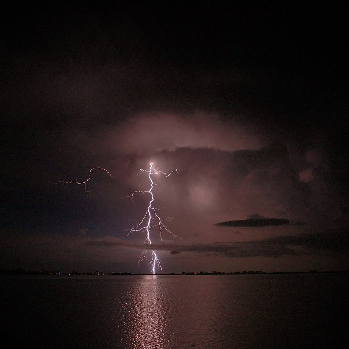 Lightning bolt over the water striking downtown Clearwater or Dunedin.