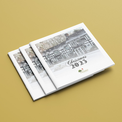 The Limes Country Lodge Hotel Christmas Brochure Front Cover. Photo of front of hotel/hotel entrance with heavy snow falling.