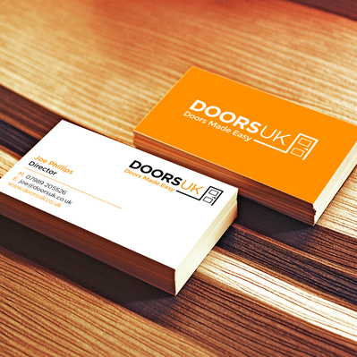 Doors UK business card on wooden surface