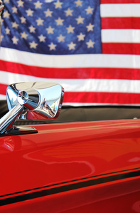 Mustang car show. Red Mustang, American flag in the background.