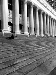 Penn Station colonnade with staircase. Midtown, New York City. B&w photography of architecture.