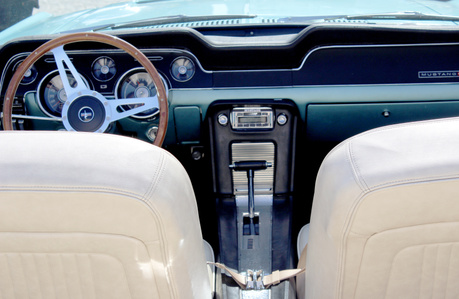 Mustang car show. Turquoise Mustang. Car interior. Wooden steering wheel.