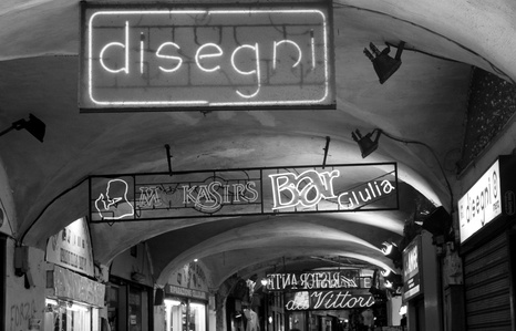 Under the arcade in Genoa, Italy. B&w photography of city architecture.