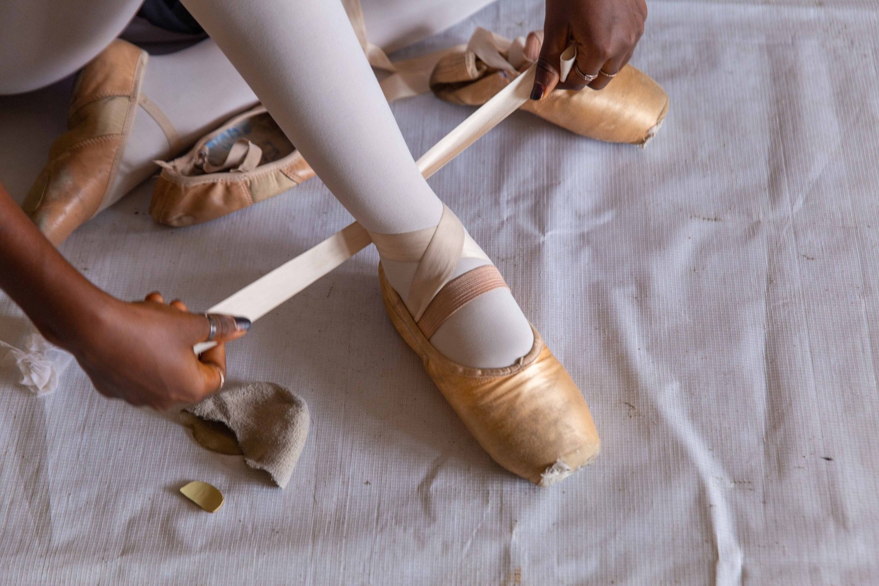A student putting on her pointe shoes during rehearsals at the Leap of Dance Academy in Lagos on July 3, 2020. Leap of Dance Academy is a ballet dance academy focused on empowering young talents who are willing to learn ballet dancing but cannot afford t