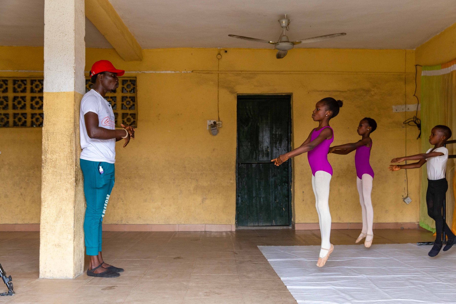 Dance tutor Daniel Owoseni Ajala showing the students ballet stretch routines during rehearsals at Leap of Dance Academy in Ajangbadi, Lagos on July 3, 2020. Leap of Dance Academy is a ballet dance academy focused on empowering young talents who are will