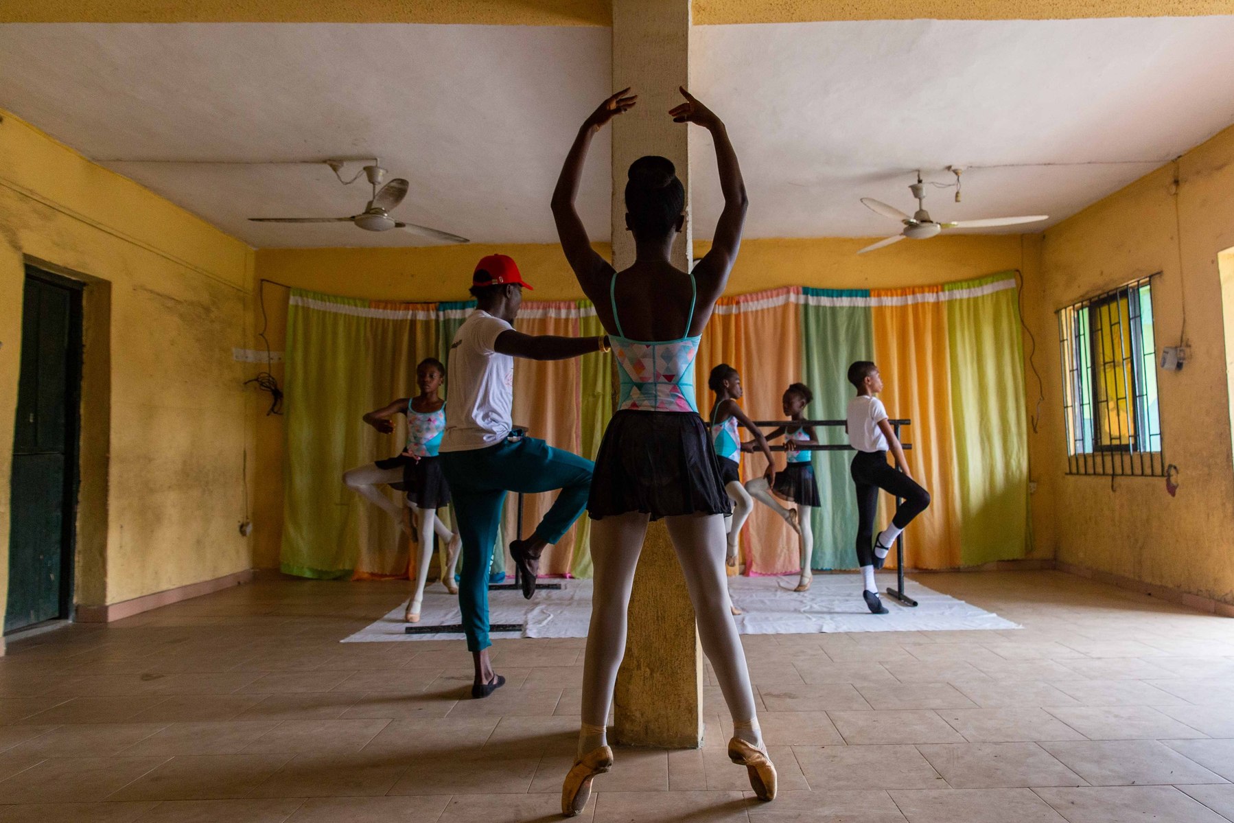 Students stretching during rehearsals at the Leap of Dance Academy in Lagos on July 3, 2020. Leap of Dance Academy is a ballet dance academy focused on empowering young talents who are willing to learn ballet dancing but cannot afford the luxury of dance