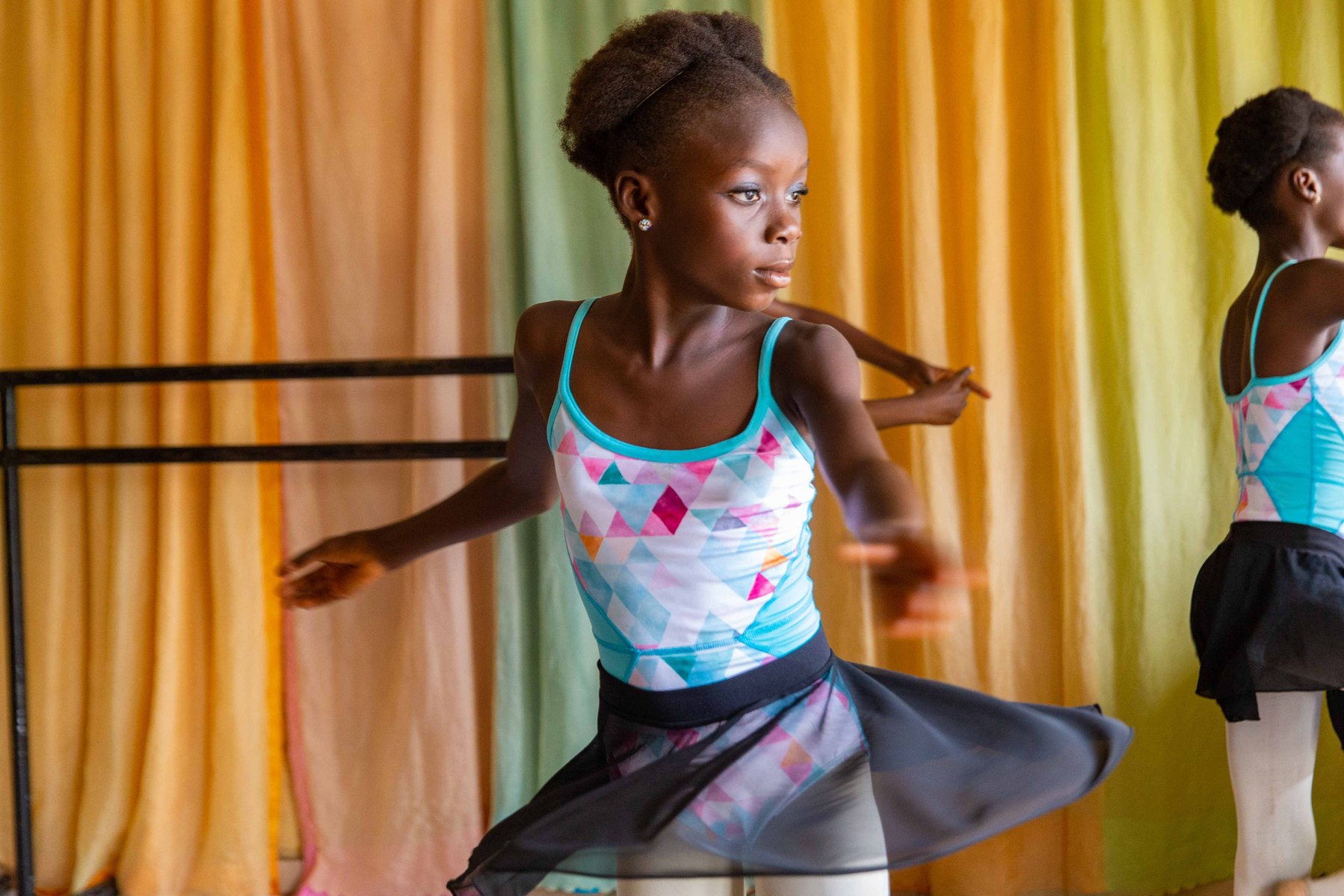 Chinemere Duru practices a pirouette while the other students wait for their turn at the Leap of Dance Academy in Lagos on July 3, 2020. Leap of Dance Academy is a ballet dance academy focused on empowering young talents who are willing to learn ballet d