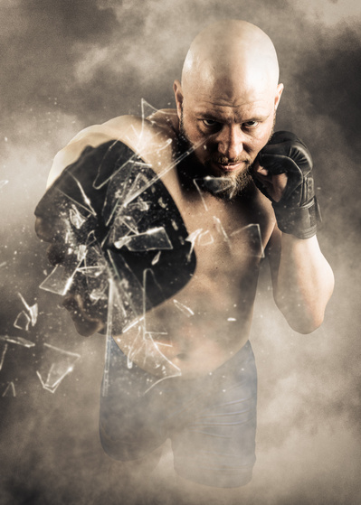 A portrait of a MMA fighter in a foggy environment throwing a punch toward the viewer and breaking a window