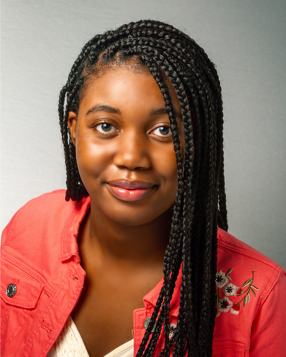 Portrait of a young girl with black hair wearing red cover jacket on a grey background