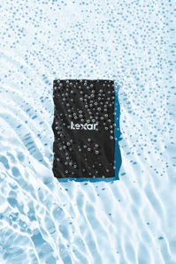 Lexar X Scott Uzoho -- product still-life photography of camera SD card floating over rippling water - moving image GIF