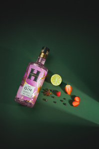 Hardaskers X Scott Uzoho -- product still-life photography of Pink Gin on emerald green flatlay with light beam and shadows 