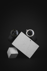 Bolido Rocks X Scott Uzoho -- product still-life photography of swiss watches balancing on concrete blocks 