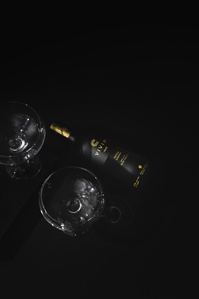 Vivir Coffee X Scott Uzoho -- product still-life photography of tequila in shadowed set and reflections of coupe glasses cocktail 