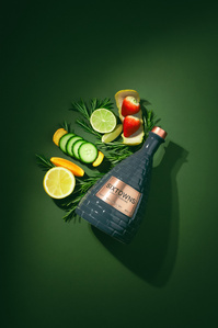 Sixtowns X Scott Uzoho -- product still-life photography of gin bottle and flavour profile fruit on emerald green background and deep shadow like spotlight 