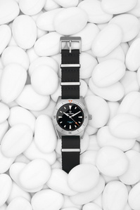 Belhamel X Scott Uzoho -- product still-life photography of swiss watch panically covered over sand with horizontal line pattern