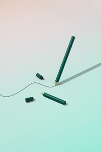 Toms Studio X Scott Uzoho -- product still-life photography of green aluminium japanese tip pens floating while inking drawing a line