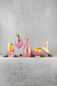 Sixtowns Pink Gin X Scott Uzoho -- product still-life photography of bottle and cocktails grouped in line of a light concrete shelf like set 