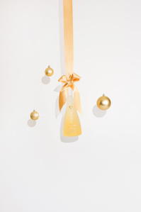 Uche rum X Scott Uzoho -- product still-life photography of dangling from gold ribbon and christmas baubles 