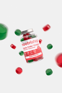 Nootishop X Scott Uzoho -- product still-life photography of supplement bottles and supplements floating around the bottle 