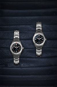 Belhamel X Scott Uzoho -- product still-life photography of swiss watches and a stainless steel strap over water droplets and blue fabric 