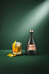 Sixtowns X Scott Uzoho -- product still-life photography of whiskey and old fashioned cocktail with orange twist. Emerald green background and light beam from the top right corner 