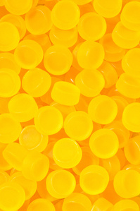 Nootrishop X Scott Uzoho -- product still-life photography of macro supplements covering the frame in a yellow glow 
