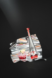 Moda X Scott Uzoho -- product still-life photography of watermelon tequila and watermelon cocktail 100% agave on cranked chrome material and black backdrop 