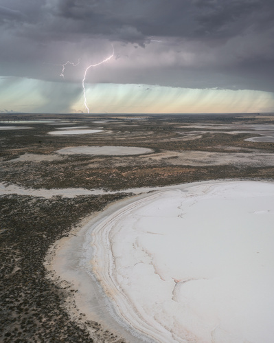 Lightning strike viewed from an aerial perspective over salt lakes.