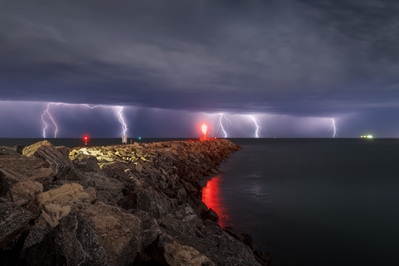 Multiple lightning strikes behind the North Mole lighthouse in Fremantle.