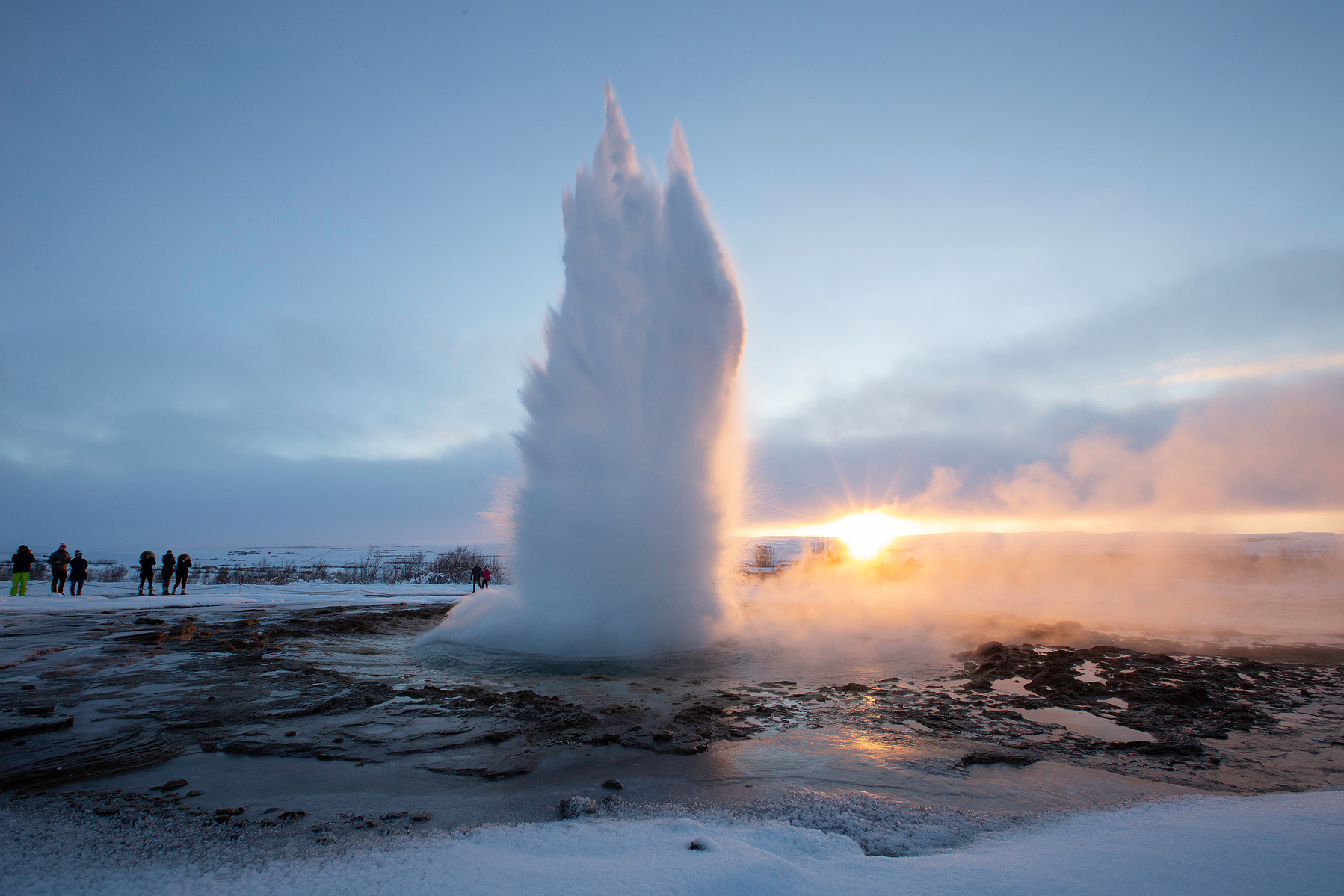 Sunrise on a winter day at Geysir Iceland as the famous geyser named after the town erupts. This is the first geyser described in a printed source and the first known to modern Europeans.