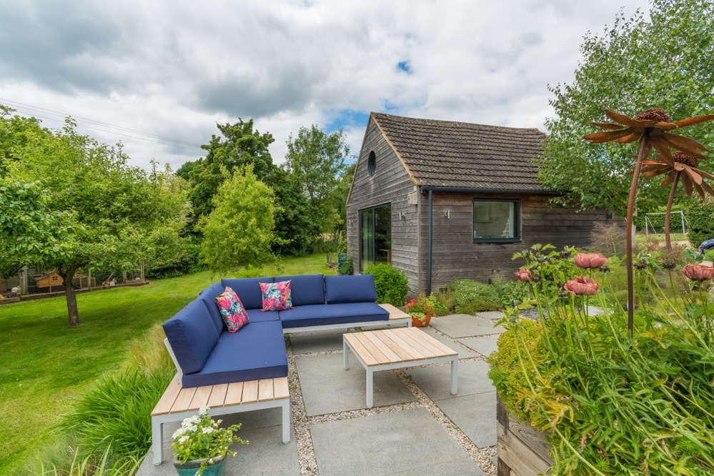 A sofa area offers the opportunity to live within the finished garden - all important to drift off with a cup of tea and a great story.