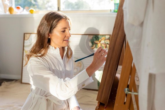 Marissa Lico, Australian Artist based in Bathurst NSW, in her home art studio with original paintings. 